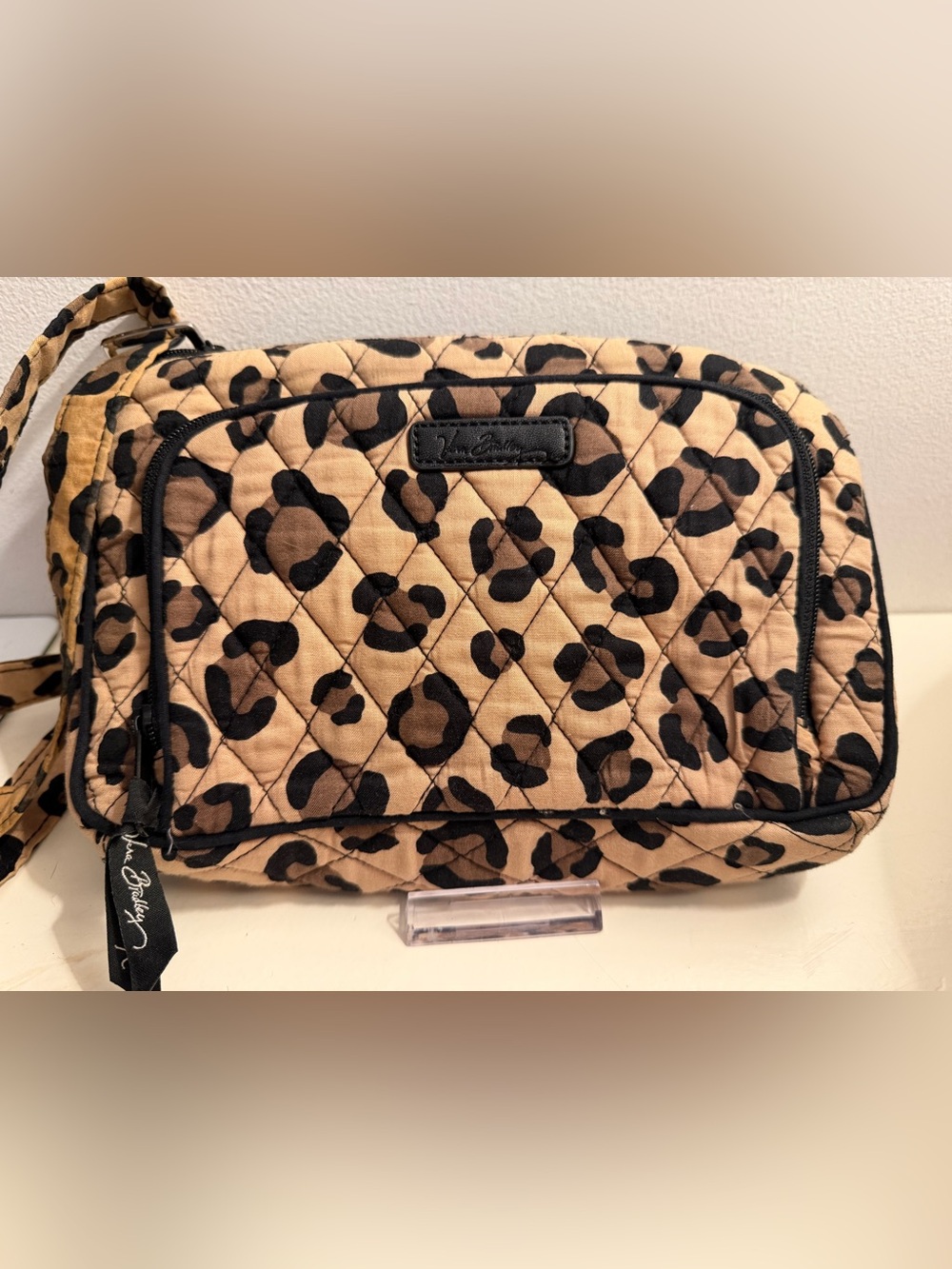 Vera Bradley black and tan leopard print crossbody bag.